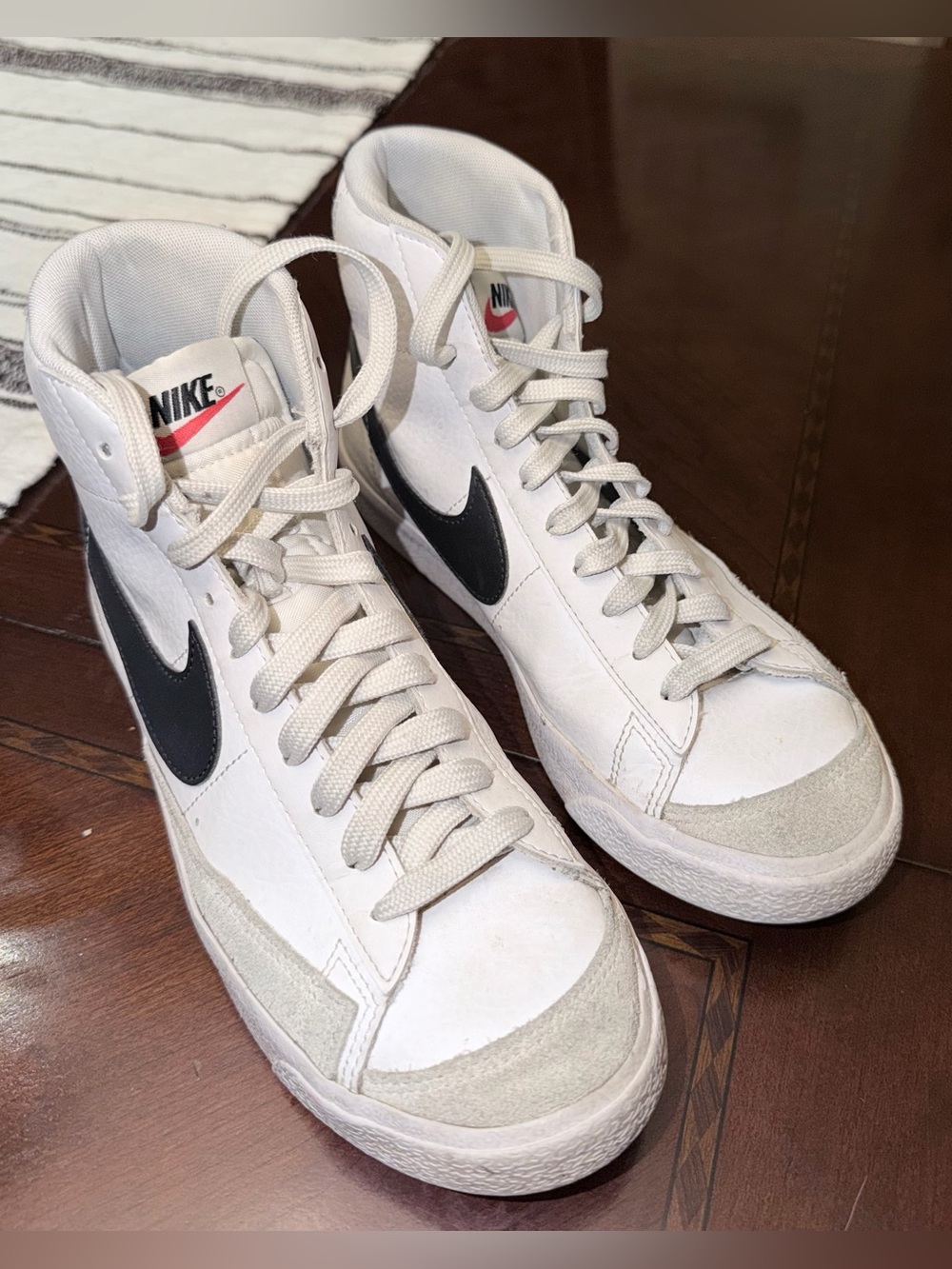 Nike White High-Top Sneakers with Black Swoosh
